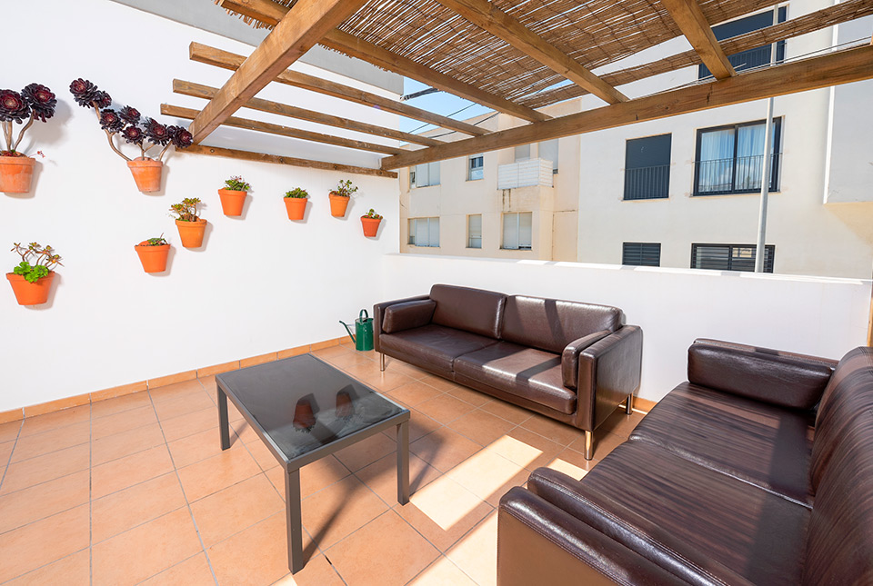 Roof terrace with chairs and plants Tarifa Kite Hostel
