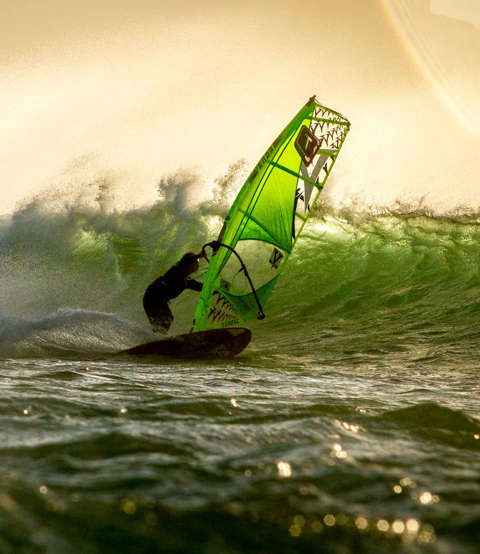 Windsurfer going down a wave